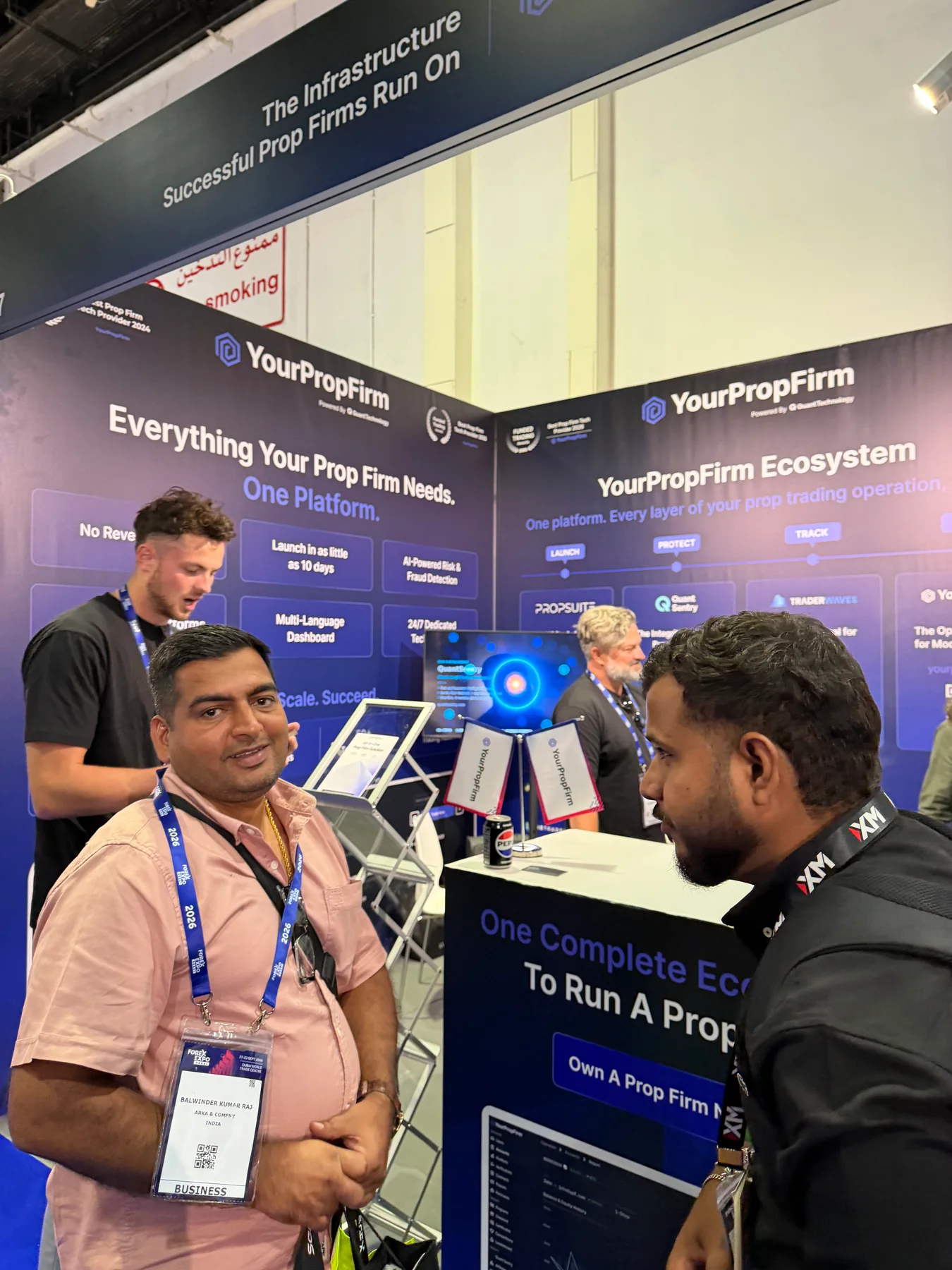 Visitors speaking with the YourPropFirm team at stand 317